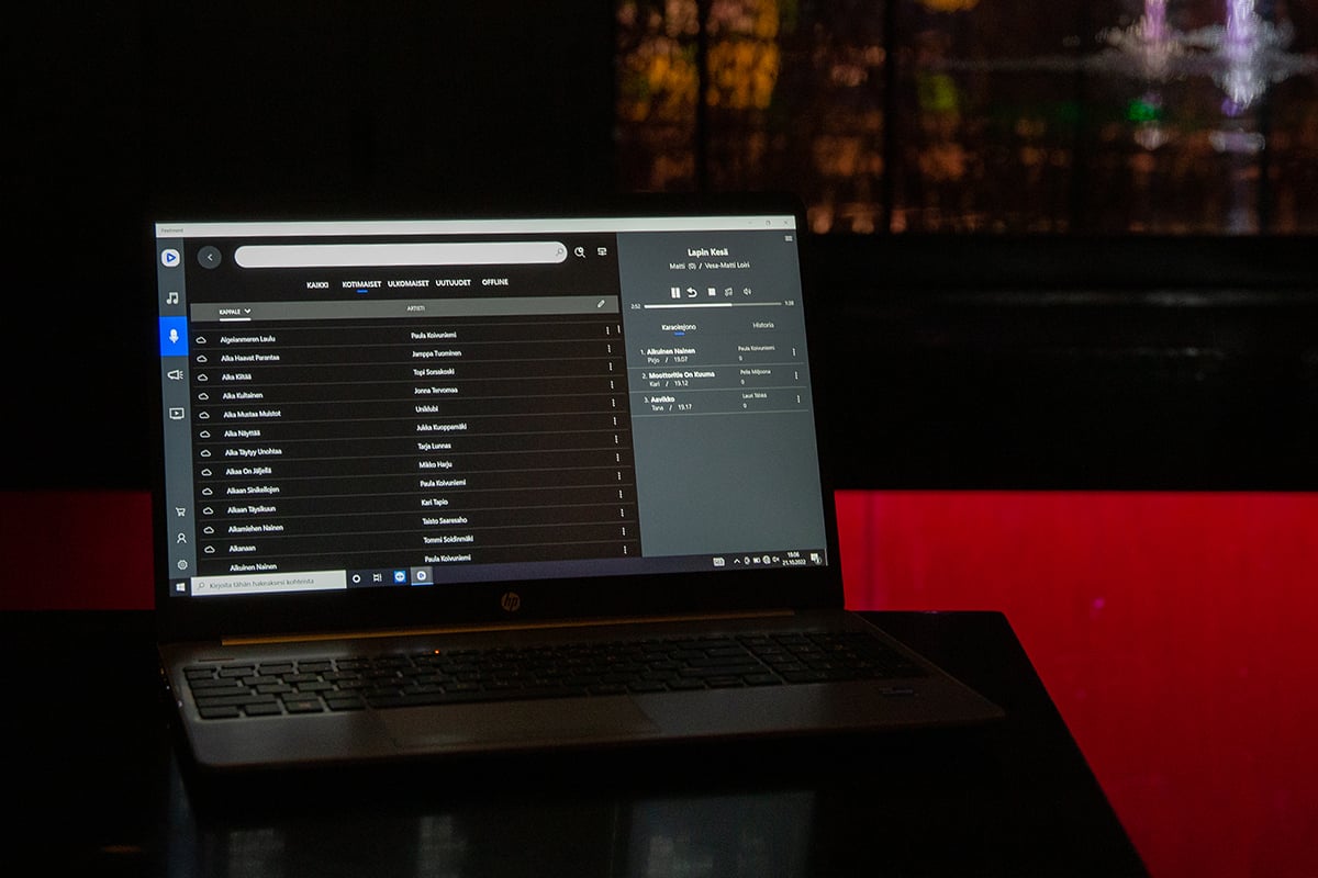 A karaoke laptop on a restarant table.