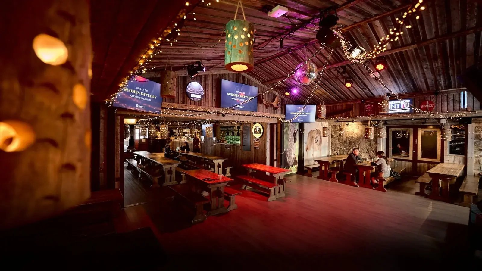 Restaurant interior. Wooden materials, warm lighting, and wooden benches and chairs.