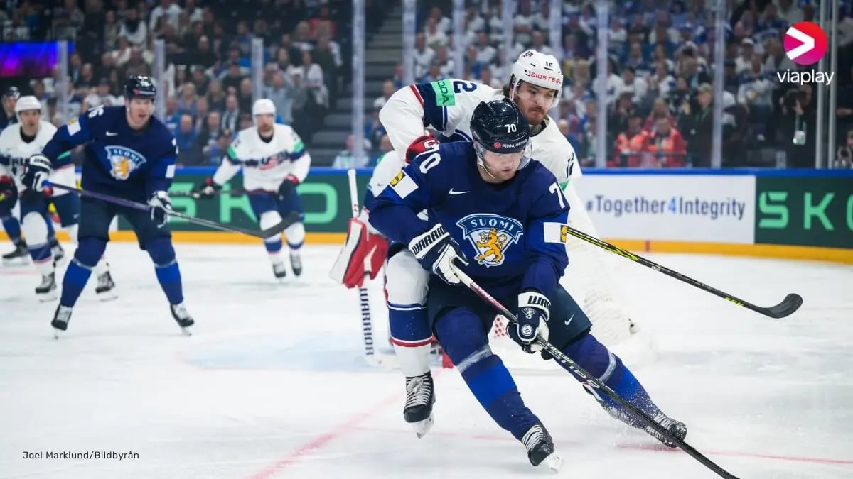 Ice hockey game situation. Two hockey players battling for the puck in the foreground of the image.