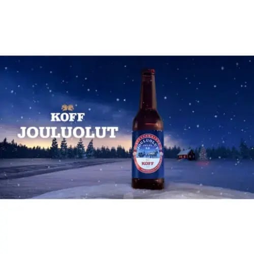 Lasinen olutpullo talvisella taustalla ja teksti: KOFF Jouluolut.