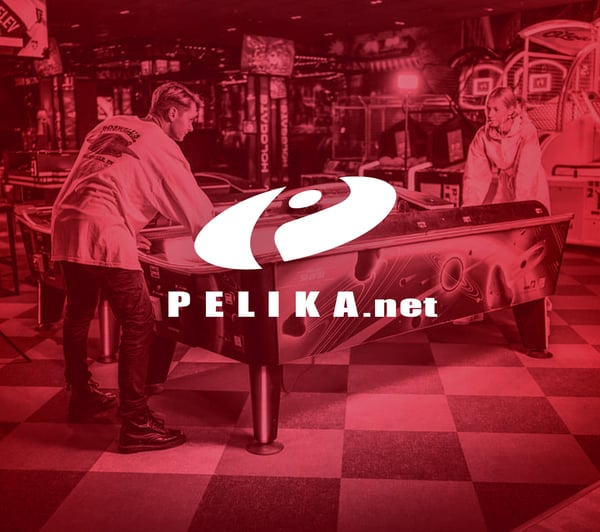 Cover photo of PELIKA. Image is covered in red, with two people playing pool in it.
