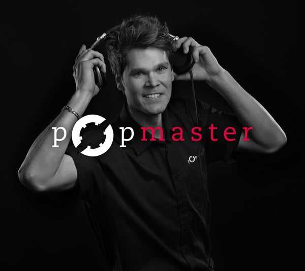 Cover phoyo of Popmaster. Image has a man holding headphones over his head. 