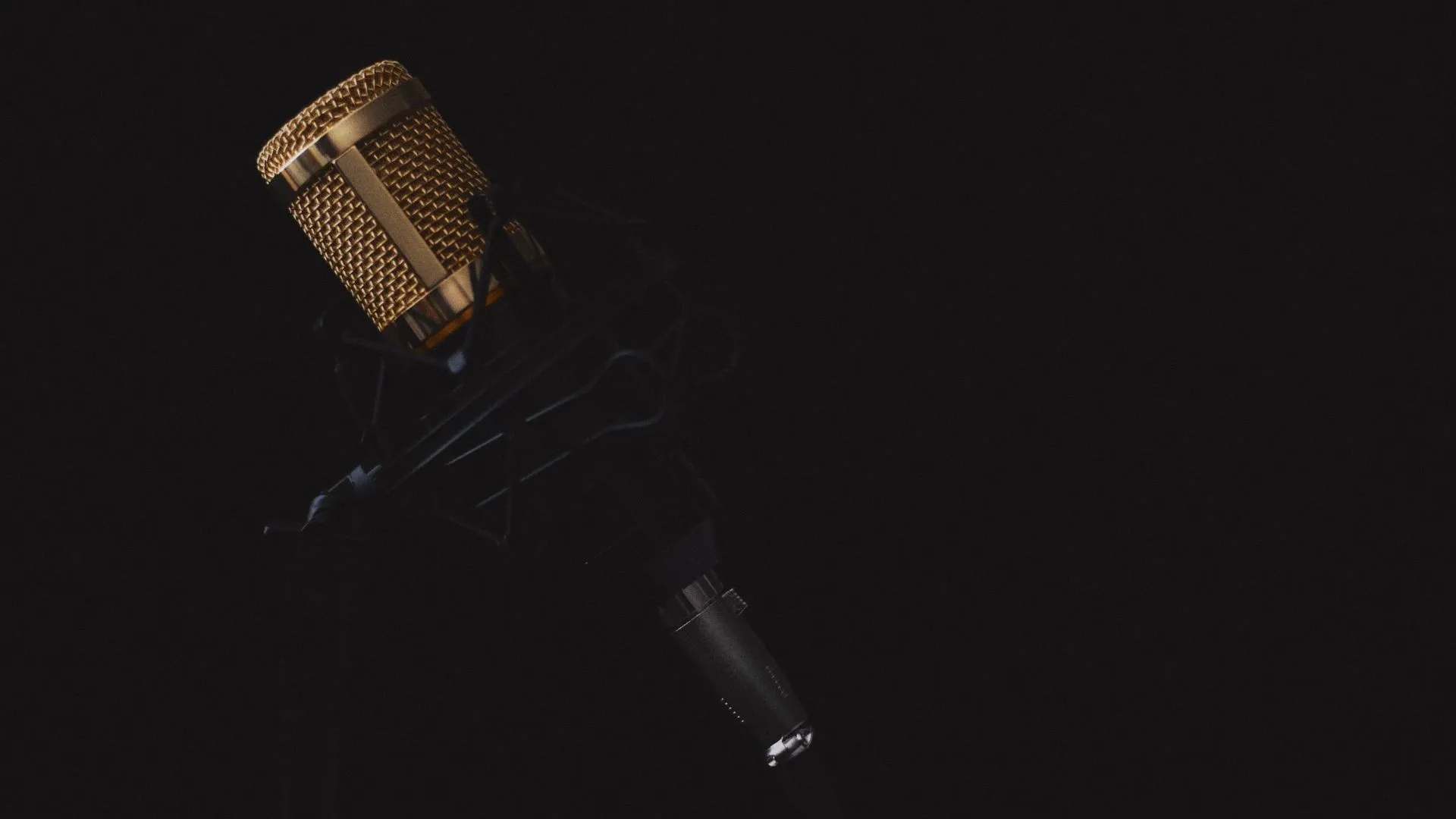 An old microphone on a black background.