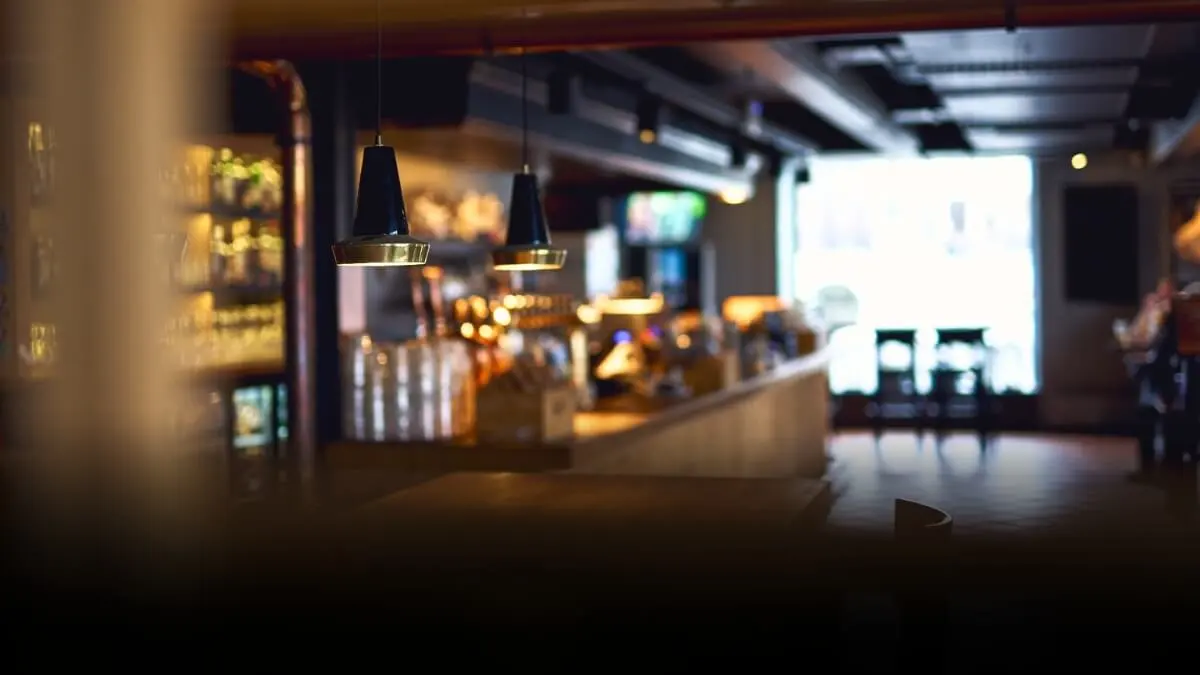 Bar counter and table. Warm lighting and comfortable atmosphere.