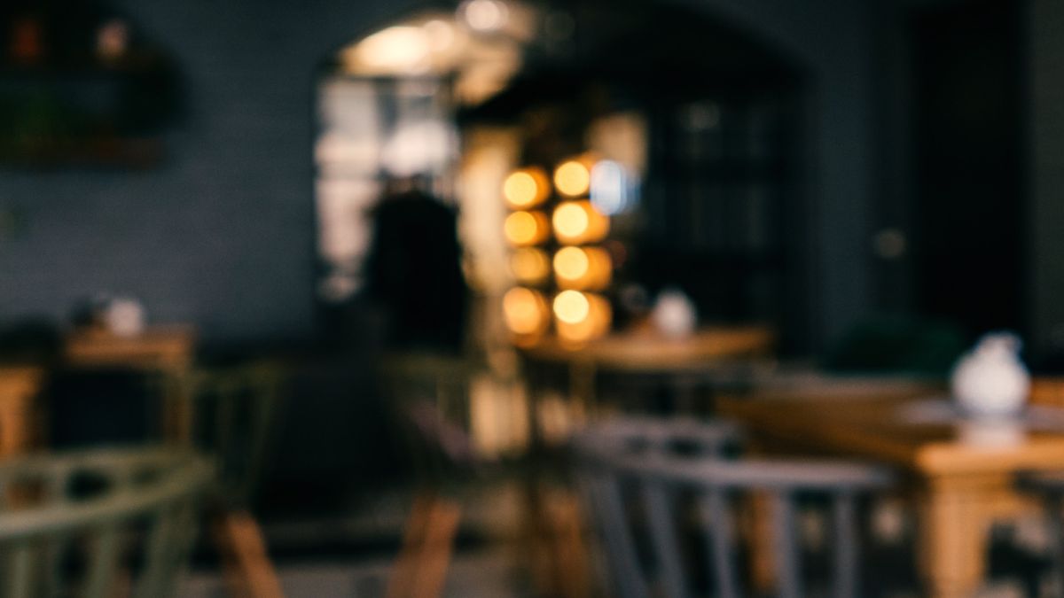 Tables and chairs in an empty restaurant.