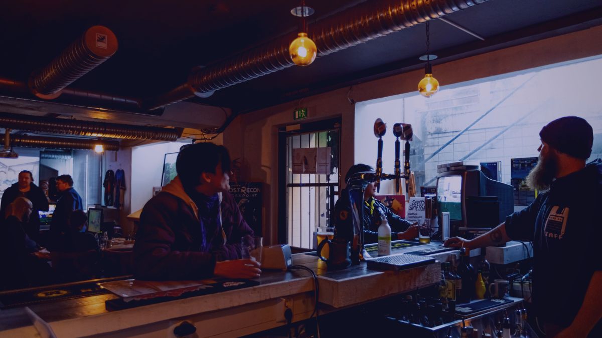 A customer leaning on the bar counter.