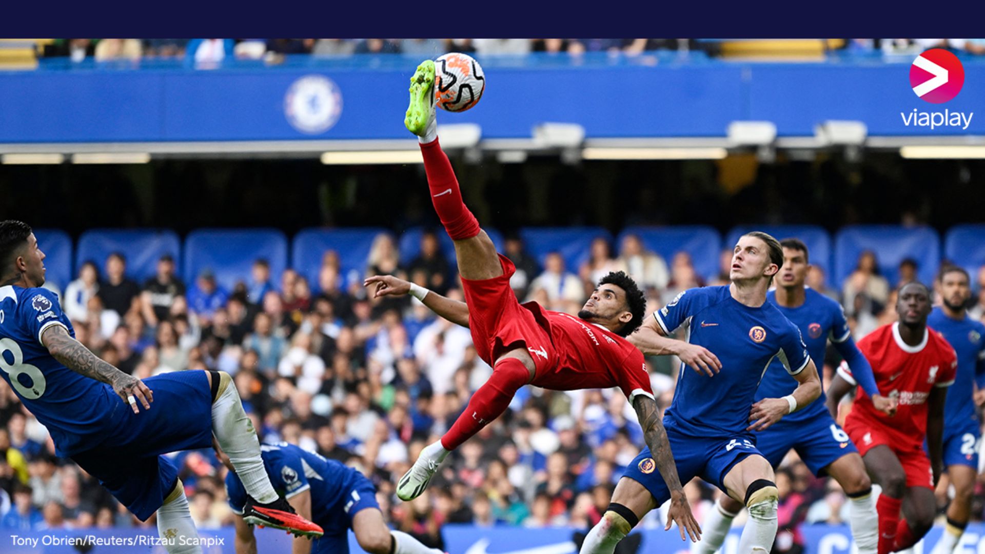 Premier League player kicking a ball enthuasiastically.